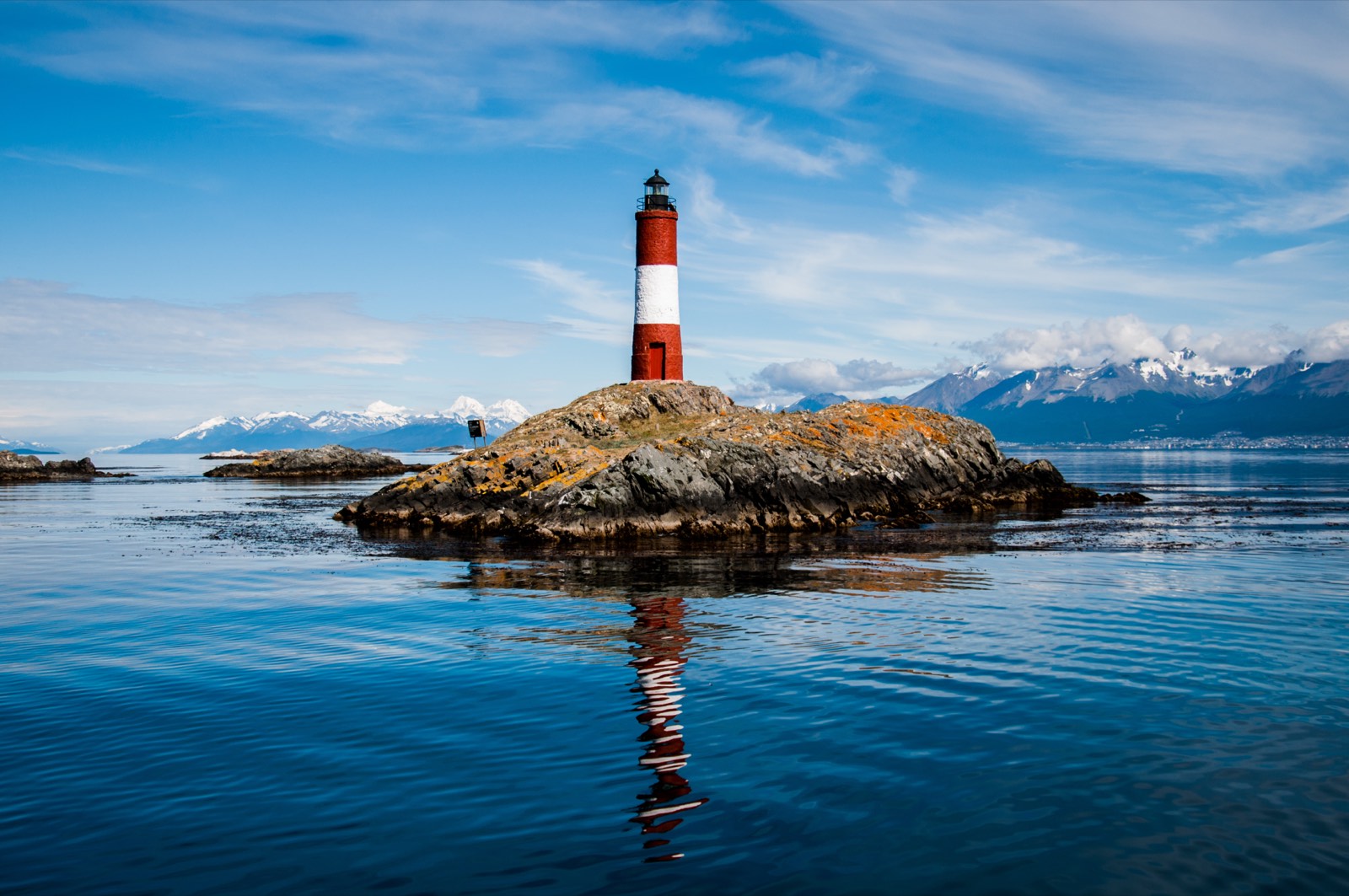 The red and white lighthouse on its rock islet in the Beagle Channel